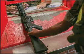  ?? (AP/U.S. Marine Corps/Lance Cpl. Ryan Hageali) ?? A recruit is issued a rifle at the Marine Corps Recruit Depot at Parris Island, S.C., in this June 2019 photo. The armory is in charge of more than 10,000 rifles on Parris Island.