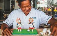  ?? AFP ?? Tam displaying two finished models of Zabivaka, the 2018 Russian World Cup mascot, made from eggshells.