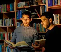  ?? AFP ?? Mossab Abu Toha and his friend Shafi Salem holding books in Toha’s family home in Beit Lahia in northern Gaza. —