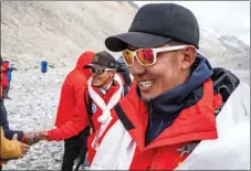  ?? SUN FEI / XINHUA ?? Dechen Ngodrup and his teammates arrive at the base camp safely on May 5.