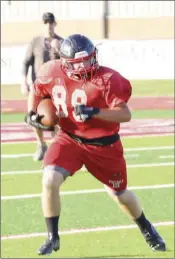  ??  ?? Russellvil­le senior Hayden Goodman carries the ball during a practice.