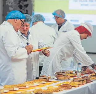  ?? Pictures: Steve Brown. ?? Around 50 judges helped to determine the world’s best Scotch pie by judging taste, shape, colour and evenness.