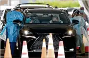  ?? AMY BETH BENNETT/SUN SENTINEL/TNS ?? A driver gets a COVID-19 vaccinatio­n on Jan. 8 at Hard Rock Stadium in Miami Gardens, Florida.