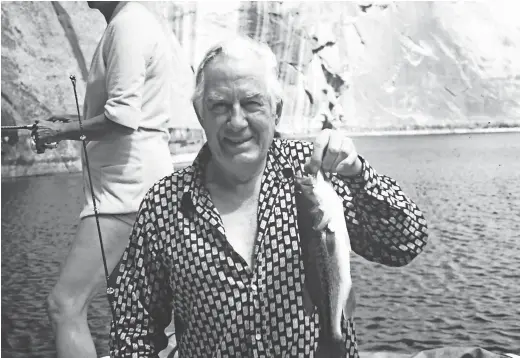  ?? PHOTOS COURTESY OF ADAM DRIGGS ?? Chief Justice Warren Burger displays one of the fish he caught on Lake Powell.