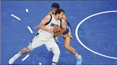  ?? USA TODAY SPORTS ?? Luka Doncic of the Dallas Mavericks tries to spin Klay Thompson of the Golden State Warriors during Tuesday’s Game 4.