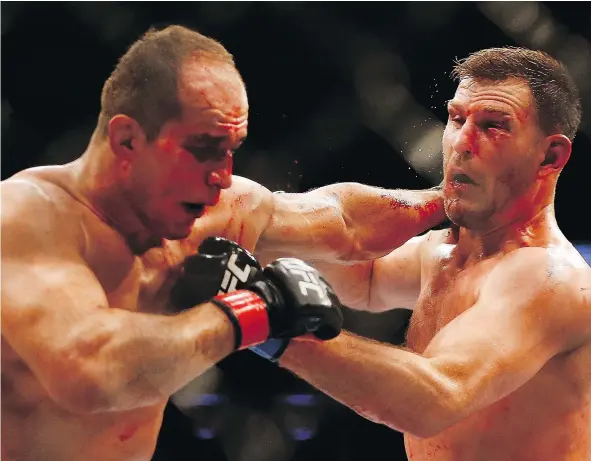  ?? — GETTY IMAGES FILES ?? Junior dos Santos, left, and Stipe Miocic exchange punches in their heavyweigh­t bout during UFC Fight Night at the US Airways Center in December, 2014 in Phoenix. Dos Santos won that match but the two fighters get together again Saturday in Texas.