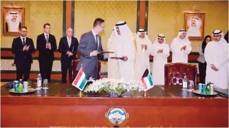  ?? —KUNA ?? KUWAIT: First Deputy Prime Minister and Minister of Foreign Affairs Sheikh Sabah Al-Khaled Al-Hamad Al-Sabah and the visiting Hungarian Minister of Foreign Affairs and trade Peter Szijjarto exchange one of three documents they signed yesterday.