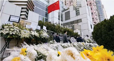  ?? Photo: Dickson Lee ?? Floral tributes are placed outside Beijing’s liaison office in Sai Wan as Hong Kong residents queue up to mourn former president Jiang Zemin yesterday.