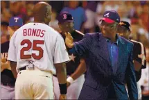  ?? THE ASSOCIATED PRESS FILE – 2004 ?? Hall of Famer Hank Aaron, right, greets Giants slugger Barry Bonds before the start of the 2004 All-Star Home Run Derby in Houston.