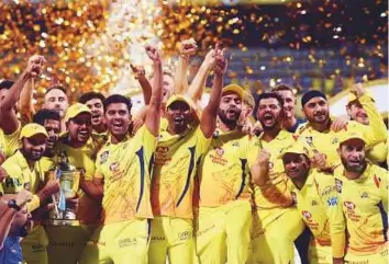  ?? PTI ?? Chennai Super Kings players celebrate with the IPL 2018 trophy after winning the final against Sunrisers Hyderabad in Mumbai on Sunday. CSK defeated SRH by eight wickets.