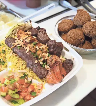  ?? MICHAEL SEARS / MILWAUKEE JOURNAL SENTINEL ?? The mixed grill plate at Al-Yousef Supermarke­t, 6329 S. 20th St., Oak Creek, combines three skewered and grilled meats: beef kofta, kebab and shish taouk.