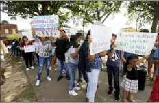  ?? ROGELIO V. SOLIS — THE ASSOCIATED PRESS ?? Children of mainly Latino immigrant parents hold signs in support of them and those individual­s picked up during an immigratio­n raid at a food processing plant, during a protest march to the Madison County Courthouse in Canton, Miss., following a Spanish Mass at Sacred Heart Catholic Church in Canton on Sunday. The raids last Tuesday at poultry plants in Mississipp­i have spurred churches that have been key to providing spiritual and emotional comfort to workers to now step up to provide material aid to jailed or out-of-work church members.