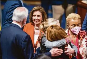  ?? J. Scott Applewhite / Associated Press ?? Speaker of the House Nancy Pelosi, D-Calif., greets Rep. Mike Thompson, D-Calif., chairman of the House Gun Violence Prevention Task Force, left, as Rep. Madeleine Dean, D-Pa., hugs Rep. Lucy McBath, D-Ga., with Rep. Barbara Lee, D-Calif., right, after passage of the gun safety bill in the House, at the Capitol in Washington on Friday.