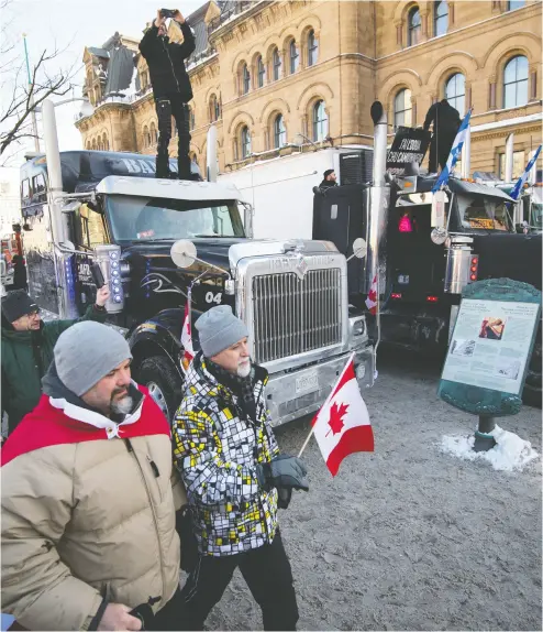  ?? JUSTIN TANG / THE CANADIAN PRESS ?? Dozens of parked trucks continued to block long stretches of Wellington St. in Ottawa outside the Prime Minister’s Office on Sunday, the second day of a rally in Ottawa against COVID-19 restrictio­ns that began as a cross-country
convoy protesting a federal vaccine mandate for truckers.