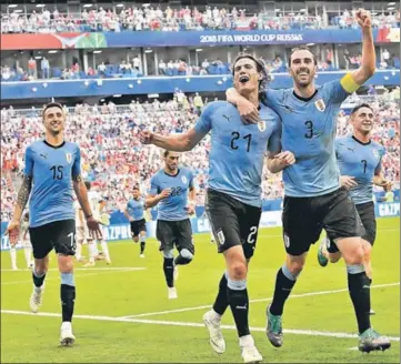  ?? AP ?? Uruguay's Edinson Cavani (centre) celebrates with teammate Diego Godin (right) after scoring his team's third goal during their Group A match against Russia in Samara on Monday.