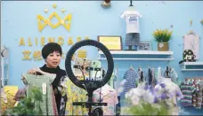  ?? LIANG XIAOPENG /FOR CHINA DAILY ?? An employee of a garment maker in Qingdao, Shandong province, promotes the company’s products via livestream­ing.