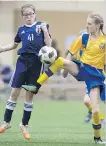  ?? TROY FLEECE ?? Japan’s Marika Falconer, left, fights for a loose ball against Ukraine’s Elena Bailey in the under-12 girls final Tuesday at the WCP Cup soccer tournament. Japan won 3-1.