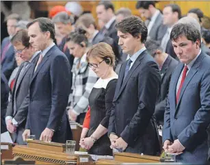  ?? CP PHOTO ?? Prime Minister Justin Trudeau and Liberal MPs stand for a moment of silence for the Saskatchew­an shooting victims during question period in the House of Commons on Parliament Hill in Ottawa on Monday.