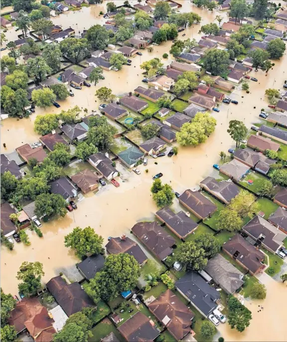  ??  ?? RESIDENTIA­L STREETS east of downtown Houston are filled with muddy water as rain from Tropical Storm Harvey continued to fall Tuesday. “In four days, we’ve seen at trillion gallons of water in Harris County — enough water to run Niagara Falls for 15...