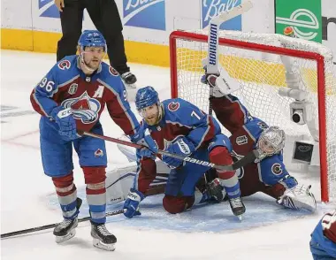  ?? Harry How/Getty Images ?? Avalanche teammates Devon Toews (7) and goalkeeper Darcy Kuemper collide in the net against the Lightning during Game 5 on Friday. Colorado is trying to win its first Stanley Cup since 2001.