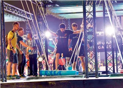  ??  ?? Sheikh Hamdan has a go at one of the obstacles during the finals of the Gov Games on Saturday evening.