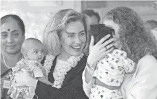  ?? JOHN GAPS III, AP ?? Hillary and Chelsea Clinton hold orphaned babies during a tour of Mother Teresa’s Orphanage in India in 1995.