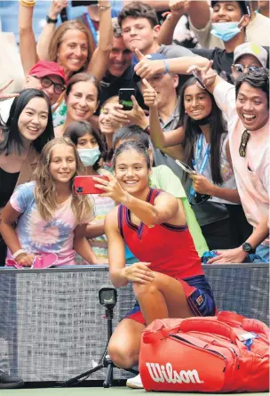  ?? PHOTO: GETTY IMAGES ?? Say cheese . . . Emma Raducanu, of Britain, takes selfies following her victory over Shelby Rogers, of the United States, at the US Open at the USTA Billie Jean King National Tennis Centre at Flushing Meadows, New York, yesterday.