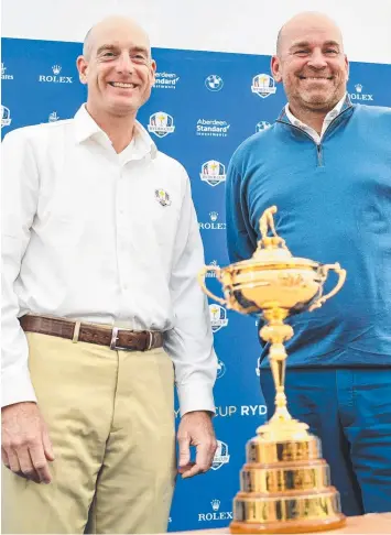  ?? Picture: AFP ?? MUTUAL ADMIRATION: Ryder Cup team captains Jim Furyk (United States) and Thomas Bjorn (Europe) pose with the Ryder Cup in Paris yesterday.