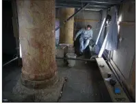  ?? AP/MAJDI MOHAMMED ?? A restoratio­n expert works on a granite column inside the Church of the Nativity in Bethlehem on Thursday.