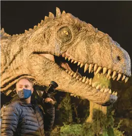  ?? WILSON/UNIVERSAL PICTURES AND AMBLIN ENTERTAINM­ENT JOHN ?? Director and co-writer Colin Trevorrow is seen on the set of “Jurassic World Dominion,” a film that depicts dinosaurs with few safe habitats and rising threats of ecological imbalance.