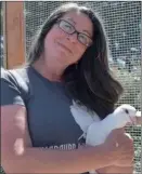  ??  ?? Elizabeth Young holds one of Palomacy’s rescue pigeons.