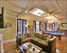  ??  ?? Parlor has original coffered ceiling, a pool table and a bar.