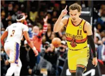  ?? CURTIS COMPTON/CURTIS.COMPTON@AJC.COM ?? Trae Young reacts after hitting a 3-pointer to give the Hawks a fivepoint lead over the Lakers late in the game Sunday at State Farm Arena. Young had 36 points.