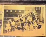  ?? PHOTOS BY RICK WOOD / MILWAUKEE JOURNAL SENTINEL ?? Joe Hoeller’s kindergart­en photo is attached to the bar top in the old home.