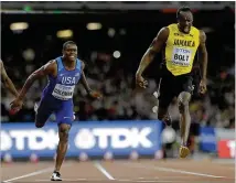  ?? DAVID J. PHILLIP / ASSOCIATED PRESS ?? Christian Coleman crosses the line with Jamaican star Usain Bolt, who settled for bronze in his final race.