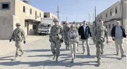  ?? PHOTOS BY LOLITA C. BALDOR AP ?? Brig. Gen. Curt Taylor, commander of the National Training Center, walks with Army Secretary Christine Wormuth as they observe soldiers training that has taken lessons learned from the Russian war on Ukraine at the National Training Center at Fort Irwin, California, on Tuesday. At right, Wormuth, right, talks with Army Col. Ian Palmer, commander of the 2nd Brigade, 1st Cavalry Division, during a break between exercises.