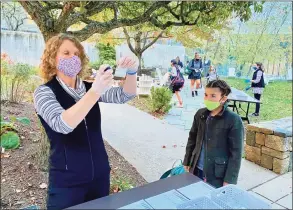  ?? Contribute­d photo ?? Michelle Summers, Greenwich Academy’s director of finance and operations — and COVID coordinato­r — collects saliva samples for testing at the private school in Greenwich.