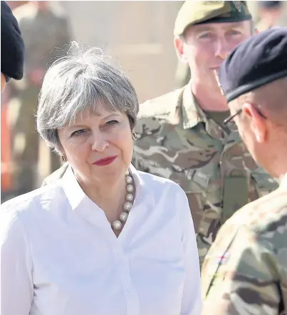  ?? Joe Giddens ?? > Prime Minister Theresa May responded to questions about the Brexit ‘divorce bill’ during her visit to meet British troops in Iraq yesterday