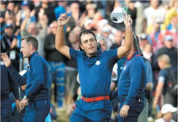  ?? AP PHOTO ?? Europe’s Francesco Molinari celebrates after winning a Friday foursome match with his partner Tommy Fleetwood on opening day of the 42nd Ryder Cup at Le Golf National in Saint-Quentin-enYvelines, outside Paris.