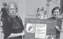  ?? Daryl Slade/calgary Herald ?? Animal rights activists Pam Bowyer, left, and Sylvia Meier stage a protest Monday outside the Calgary Courts Centre to try to get GuZoo at Three Hills in central Alberta closed down.