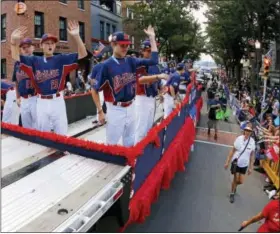  ?? GENE J. PUSKAR — THE ASSOCIATED PRESS ?? Members of the Mid-Atlantic champion team from Jackson, N.J. ride in the Little League Grand Slam Parade in downtown Williamspo­rt on Wednesday.