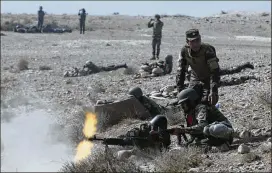  ?? MASSOUD HOSSAINI / AP ?? Afghan National Army commandos open fire in an exercise Tuesday in Kabul. A provincial police chief was among those killed during the day in Taliban attacks.