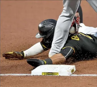  ?? Matt Freed/Post-Gazette ?? Erik Gonzalez is tagged out Thursday on an attempted steal of third base in the third inning at PNC Park. The Indians defeated the Pirates, 2-0.