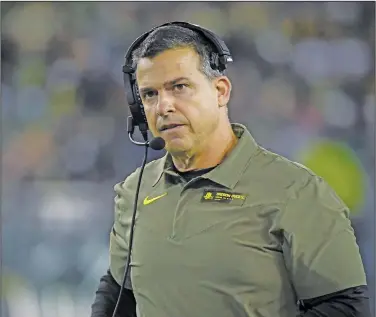  ?? Associated Press ?? Cristobal takes over at Miami: Oregon head coach Mario Cristobal watches the action during the third quarter of an NCAA college football game last month in Eugene, Ore. Manny Diaz was fired as Miami’s football coach Monday after a 7-5 regular season and the school hired Cristobal to take over at his alma mater.