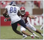  ?? (NWA Democrat-Gazette/Charlie Kaijo) ?? Arkansas defensive back Greg Brooks Jr. tackles Rice wide receiver August Pitre III in the first quarter of Saturday’s game at Reynolds Razorback Stadium in Fayettevil­le. The Hogs overcame a sloppy first half to get the opening-season victory.
