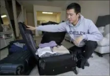  ?? BEN MARGOT — THE ASSOCIATED PRESS ?? In this Monday photo, Leo Wang packs a suitcase at his home in San Jose Wang has found himself trapped in an obstacle course regarding H-1B work visas for foreigners. His visa denied and his days in the United States numbered, Wang is looking for work outside the country. “I still believe in the American dream,” he says. “It’s just that I personally have to pursue it somewhere else.”