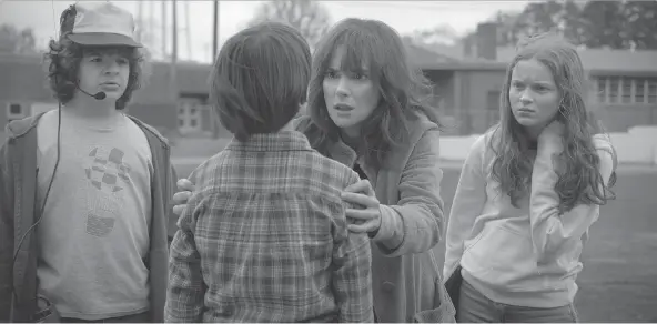  ?? NETFLIX ?? Winona Ryder, centre, and the children of Stranger Things are back in Hawkins, Ind., for a second season of terrifying small-screen moments.