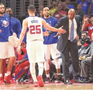  ?? STEPHEN DUNN, GETTY IMAGES ?? Austin Rivers, left, greeted by his father, Doc, is averaging 9 points a game in the playoffs.