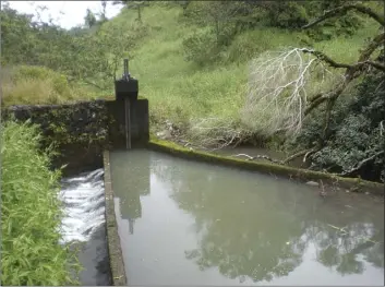  ??  ?? The East Maui Irrigation system collects water from East Maui streams and takes it to Upcountry and Central Maui. This photo taken in 2016 is of a gate shut-off of the Wailua Stream. The state Board of Land and Natural Resources approved Alexander & Baldwin’s and Mahi Pono’s request for a permit to divert water from state land in East Maui in 2021.