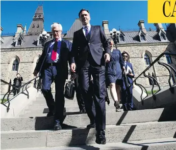  ?? SEAN KILPATRICK / THE CANADIAN PRESS ?? Natural Resources Minister James Carr and Finance Minister Bill Morneau leave a cabinet meeting on Parliament Hill Tuesday, after announcing that Canada is going to buy the Trans Mountain pipeline.
